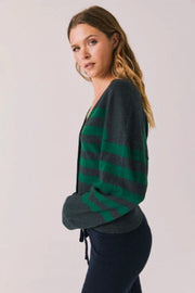 Woman wearing a green and gray striped cardigan