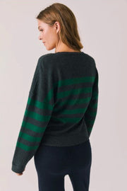 Woman wearing a green and gray striped cardigan