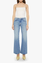 Woman wearing light blue flared jeans with a twist detail