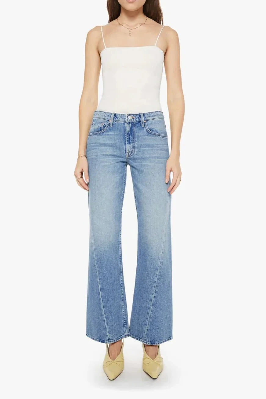 Woman wearing light blue flared jeans with a twist detail