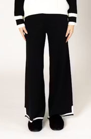 Person wearing black pants with white trim