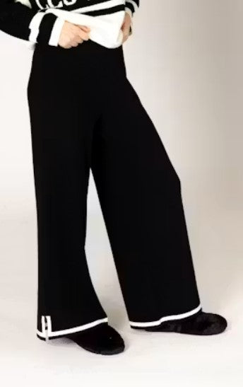 Person wearing black pants with white trim