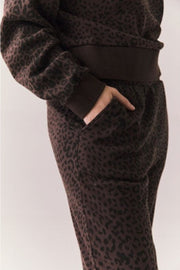 Side view of a person wearing a brown leopard print pant