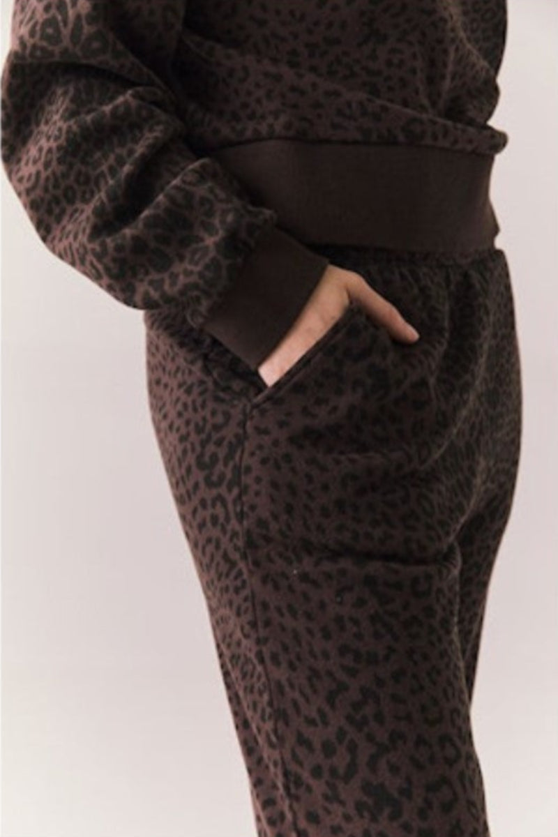Side view of a person wearing a brown leopard print pant