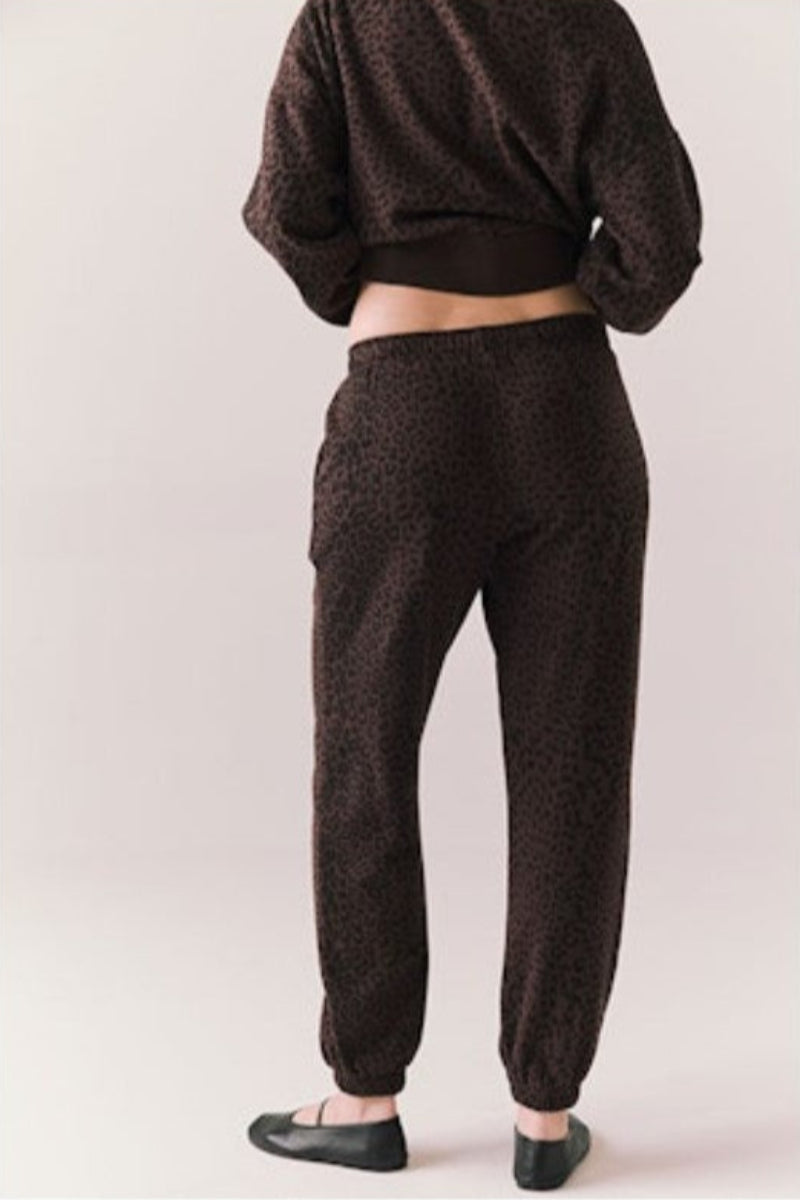 Person wearing brown patterned pants and a matching top 