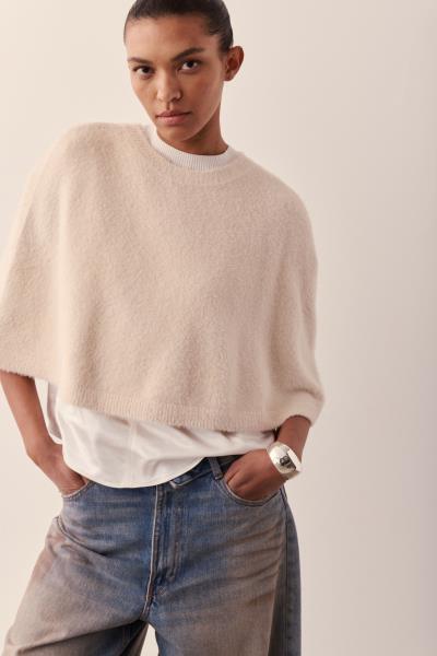 women wearing cream knit cape