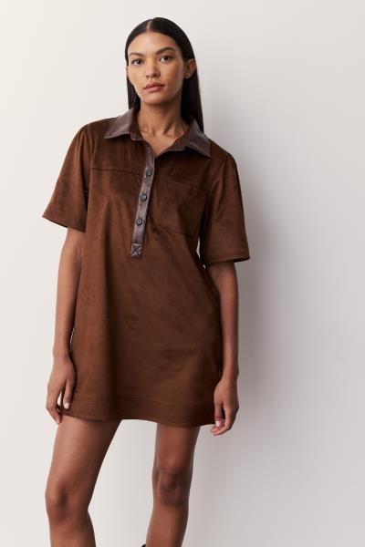 A woman modeling a brown faux suede short-sleeve collared shirt dress