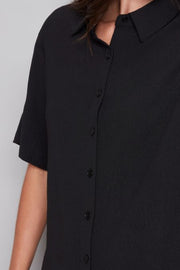 Close-up a black shirt and shorts set 