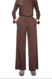 Woman wearing a brown satin set outfit on a white background