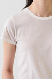 close up of woman wearing a eggshell white tee shirt