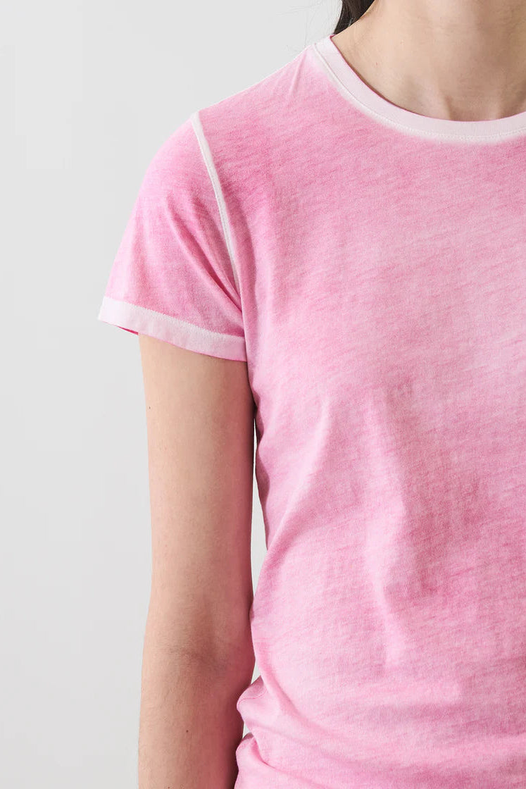 close up of woman wearin a faded pink tee shirt
