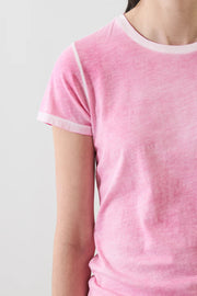 close up of woman wearin a faded pink tee shirt