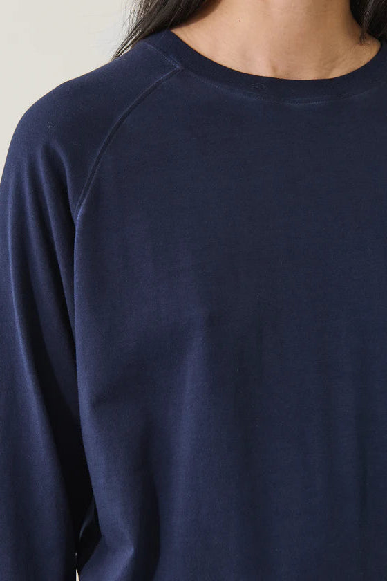 Navy blue oversized sweatshirt worn by a person on a neutral background