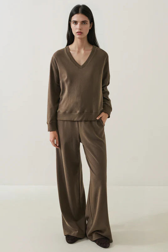 woman wearing a Pima cotton chestnut brown drawstring jogger and v-neck sweatshirt