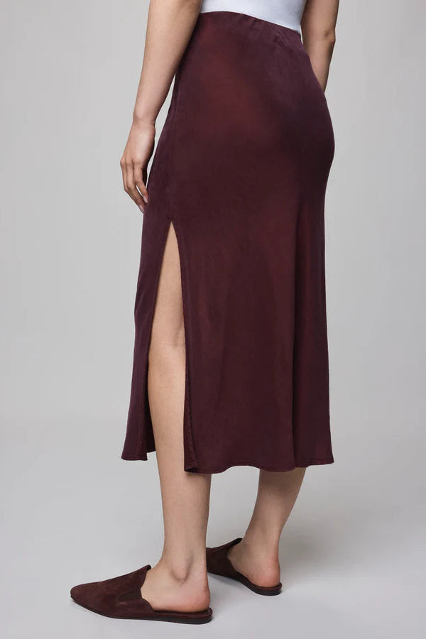 Burgundy skirt with a slit on a plain background