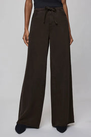 Brown wide-leg pants worn by a person on a white background