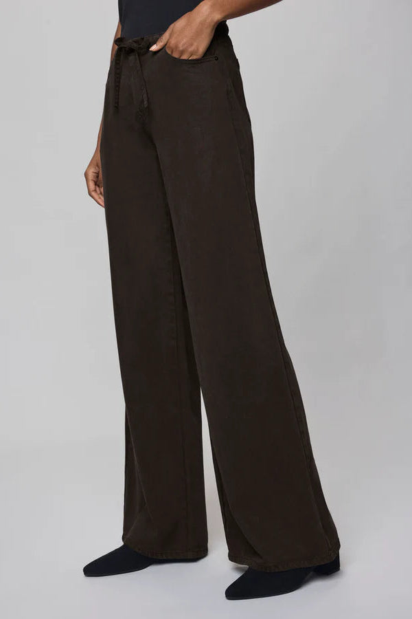 Brown wide-leg pants worn by a person on a light gray background