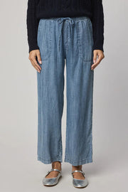 Woman wearing indigo wide leg pants with waist tie