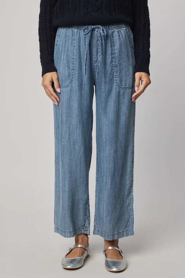 Woman wearing indigo wide leg pants with waist tie