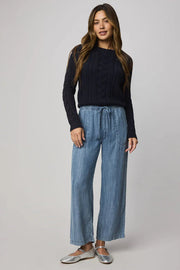 Woman wearing indigo wide leg pants with waist tie