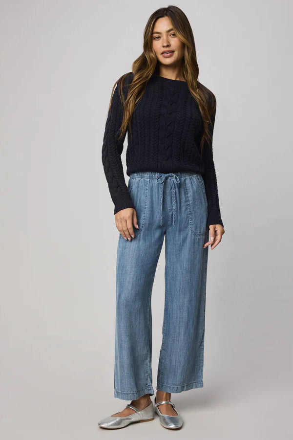 Woman wearing indigo wide leg pants with waist tie