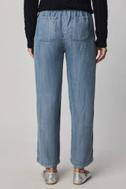 Woman wearing indigo wide leg pants with waist tie