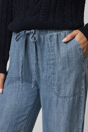 Woman wearing indigo wide leg pants with waist tie
