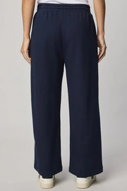 woman wearing a navy ankle length wide leg pant
