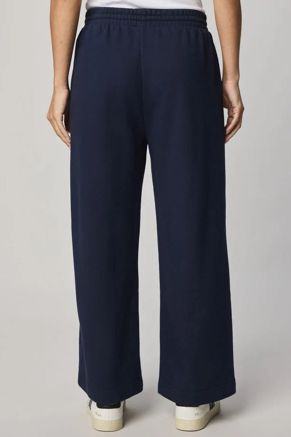 woman wearing a navy ankle length wide leg pant