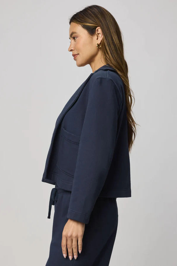 woman wearing a navy blue 100% cotton blazer 