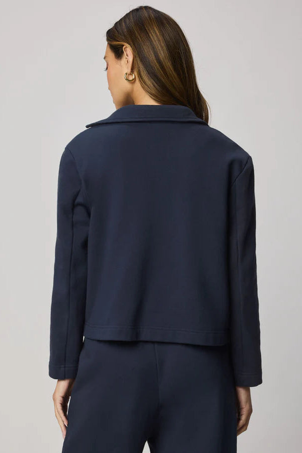 woman wearing a navy blue 100% cotton blazer 