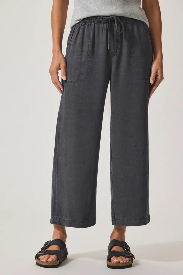 Person wearing dark gray wide-leg pants
