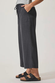 Person wearing dark gray wide-leg pants