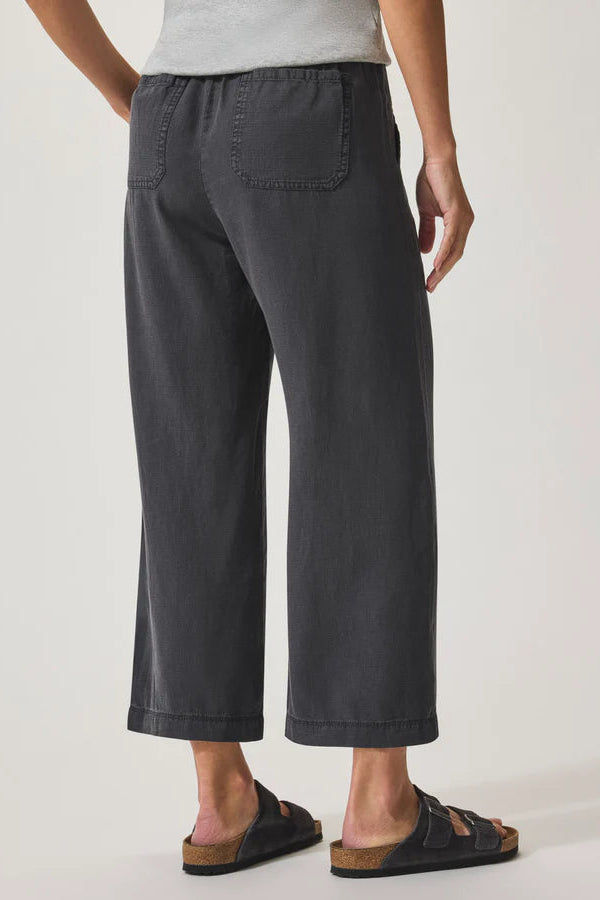 Person wearing dark gray wide-leg pants