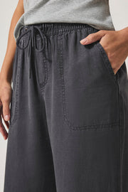 Person wearing dark gray wide-leg pants