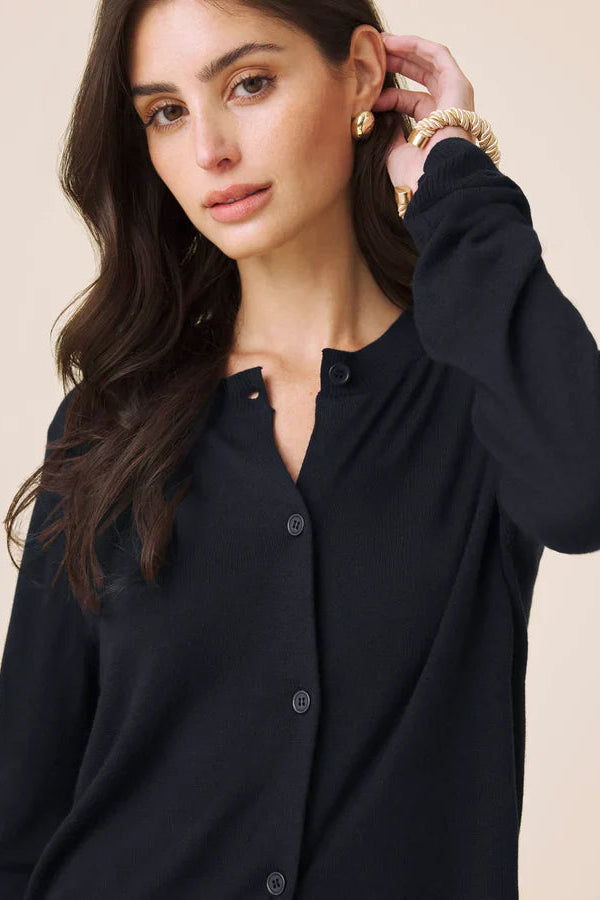 Woman wearing a navy button up cardigan 