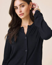 Woman wearing a navy button up cardigan 