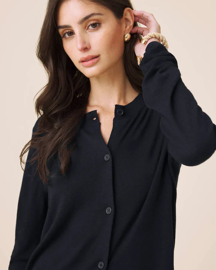 Woman wearing a navy button up cardigan 