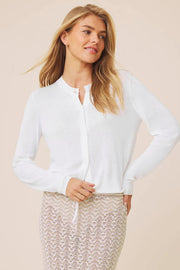 Woman wearing a white long-sleeve button up knit cardigan 
