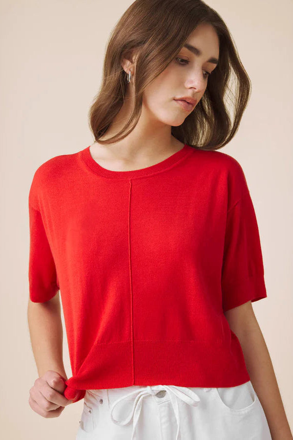 Woman wearing a red light weight tee 