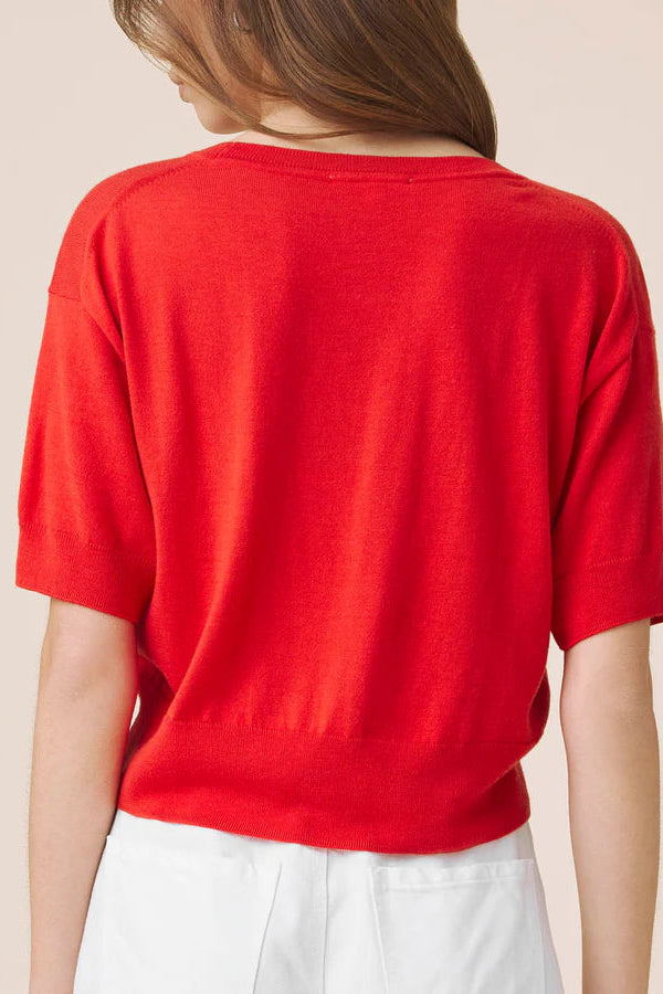 Woman wearing a red light weight tee 