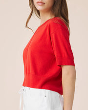 Woman wearing a red light weight tee 