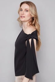 woman wearing a black off the shoulder bow top 