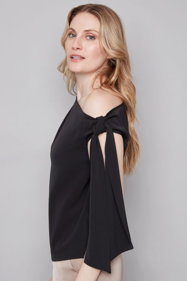 woman wearing a black off the shoulder bow top 
