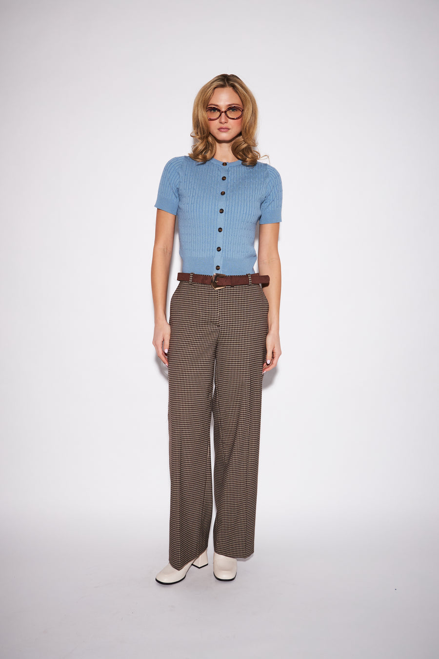 model wearing a light blue ribbed short sleeve button down knit cardigan 