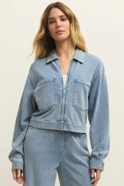 Woman wearing a light blue denim zip front jacket with chest pockets, front view