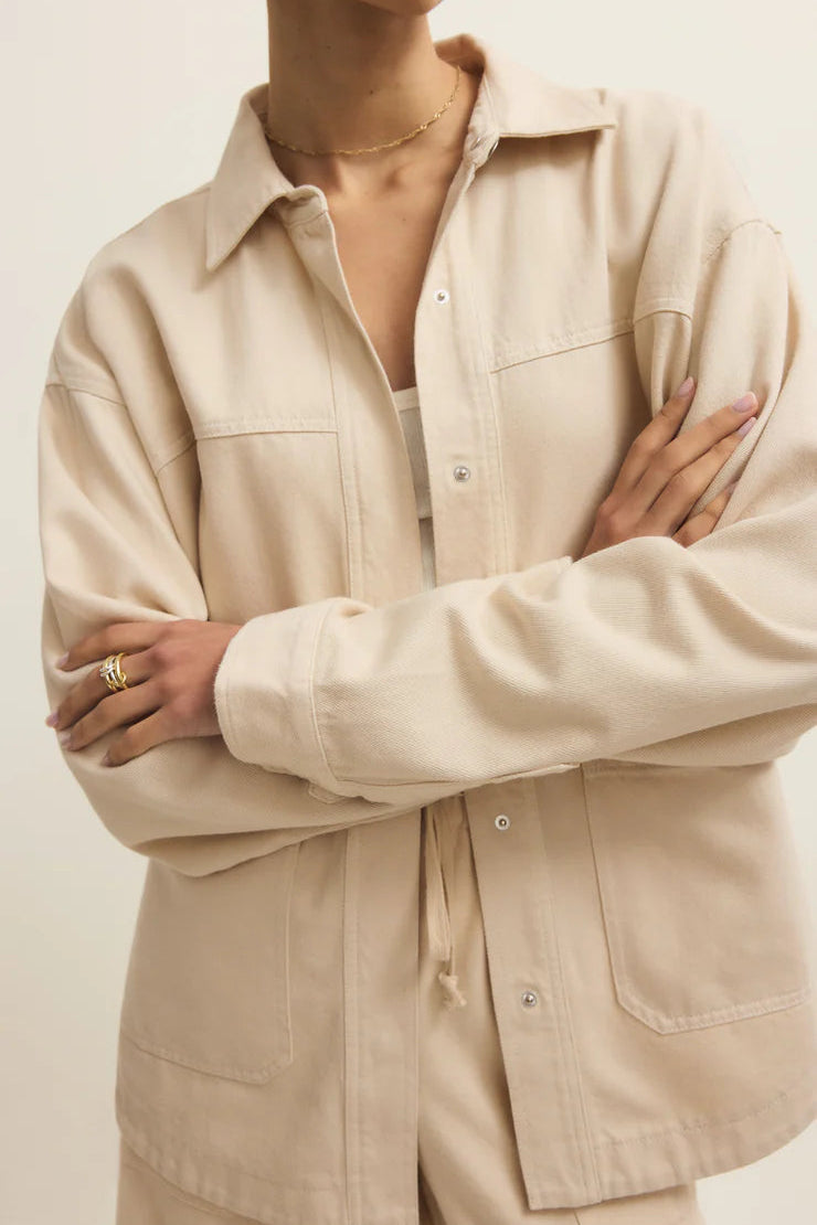 close up of light beige twill collared button up jacket 