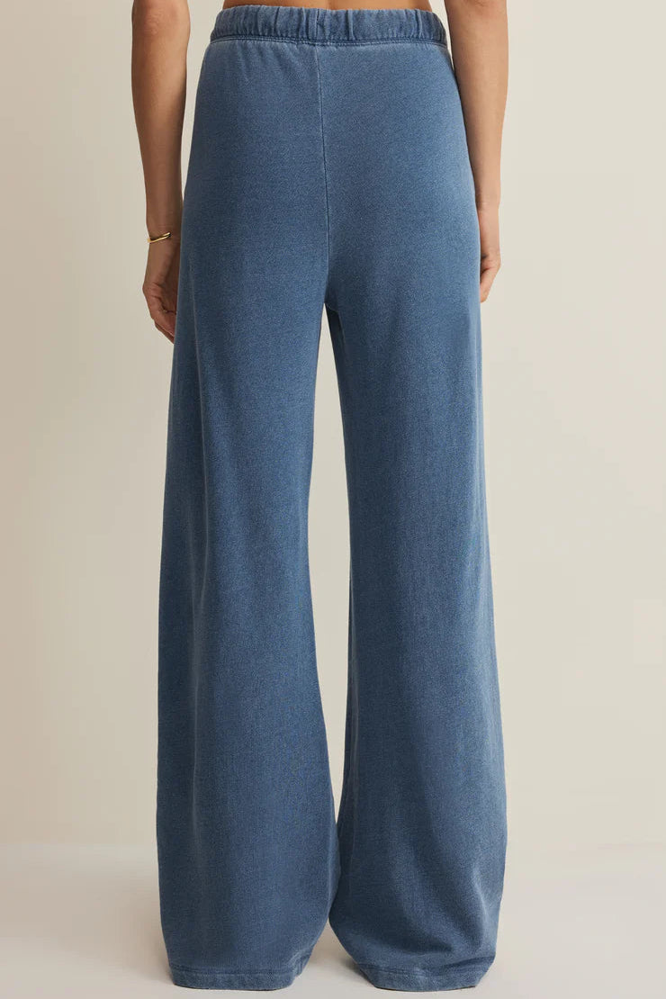 woman wearing blue wide leg lounge pants with a drawstring waist and relaxed fit, back