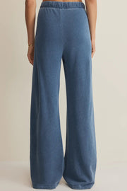 woman wearing blue wide leg lounge pants with a drawstring waist and relaxed fit, back