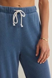 woman wearing blue wide leg lounge pants with a drawstring waist and relaxed fit, drawstring detail